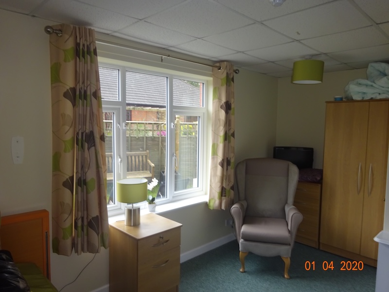 bedroom with window and armchair